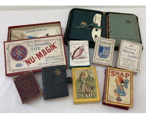 A collection of vintage playing cards, toys and card games. To include Elektrotechnik cased bridge set, boxed Nu-Magik scient