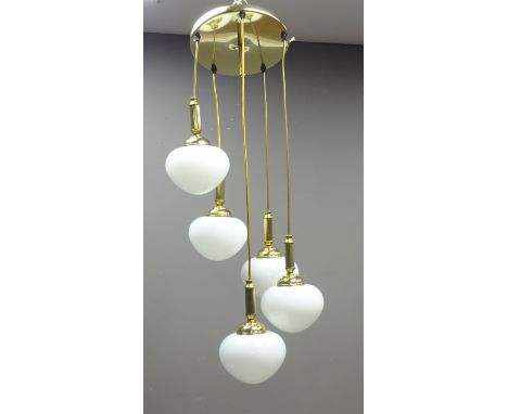 Two matched Darr lighting centre light fittings, the gilt metal fitting having five descending pendant drops with opaque bulb