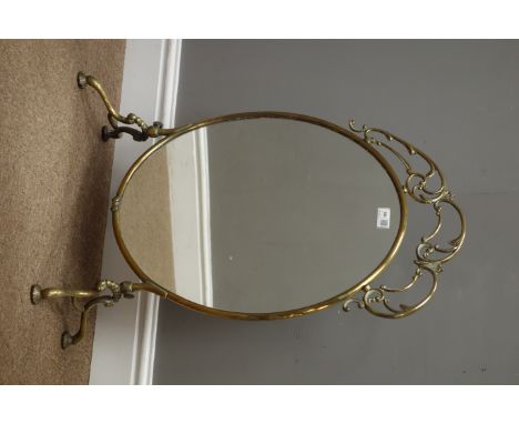 Victorian oval brass framed fire screen, with scroll work top, mirror inset on four splayed bun feet, H71cm x W49cm    Condit