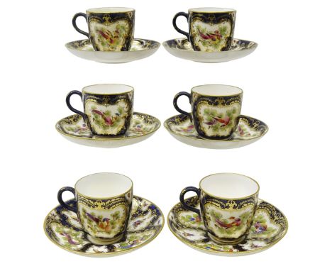 Set of six early 20th century Royal Worcester coffee cups and saucers, decorated with cartouche panels of exotic birds and in