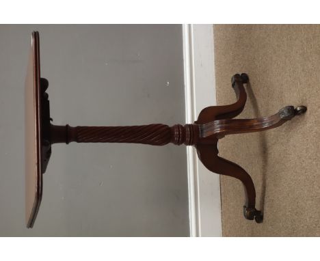 Regency mahogany tripod table, square tilt top on twist column support, three moulded legs with brass sockets and castors, 45