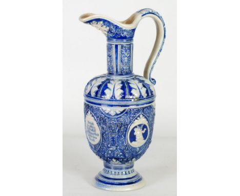 LATE NINETEENTH CENTURY WESTERWALD, GERMAN SALT GLAZED MOULDED STONEWARE PEDESTAL EWER, decorated with a pair of portrait rou