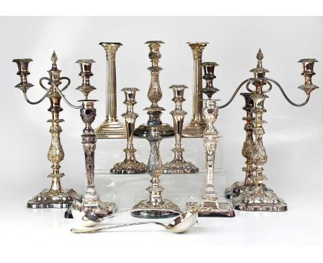 Four pairs of silver-plated candlesticks, a pair of two-branch candelabra, a single candlestick, two plated ladles, and two p