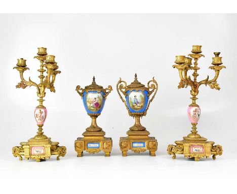 Two pairs of late 19th century gilt brass and porcelain mounted clock garnitures (both lacking clocks), height of tallest 38c