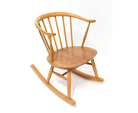 ERCOL; a light elm rocking chair with horseshoe-shaped back, remnants of sticker to the reverse, height 71cm.