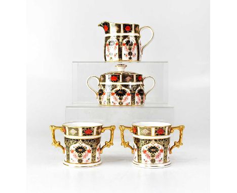 ROYAL CROWN DERBY; an Imari pattern no.1128 part tea service, comprising two twin-handled cups, height 7.5cm, a milk jug and 