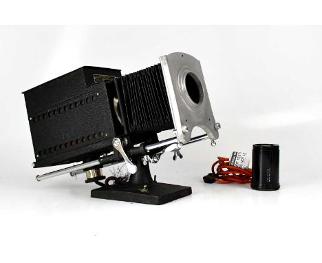 An Ensign Optiscope No. 9 lantern slide projector, with wooden slide carriers and lens.