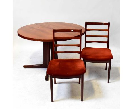 STOLE MOBELFABRIK; a Danish circular teak extending dining table on X-frame support, together with four matching ladder back 