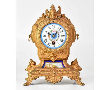 A 19th century French mantel clock with Sèvres-style porcelain face and panel, the case gold painted and with caryatid surmou