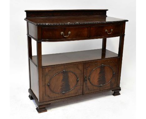 WILLIAM WHITELEY LTD; an Edwardian mahogany buffet sideboard with stop fretwork galleried top, above a bow-fronted pair of dr