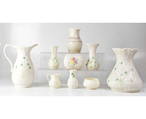 BELLEEK; nine porcelain items including a 'Love Claddagh Harmony' candleholder, a vase with pink and gilt embossed chevron bo