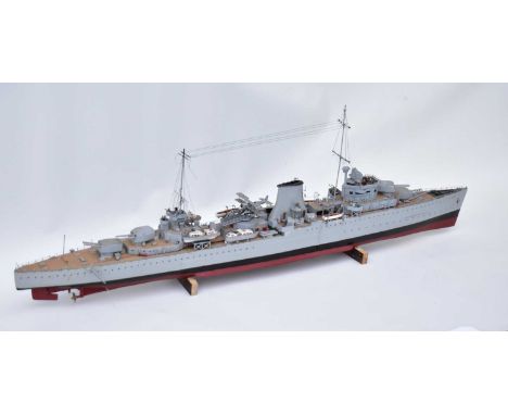 A Naval model battleship with gun turrets, biplane on deck, small boats, painted detail and deck ornaments, grey body, red/bl