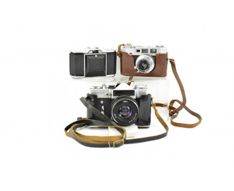 Three vintage cameras, comprising a Zenit EM 35mm camera with Helios-44M lens, in leather case, a Pax M4 camera, in leather c