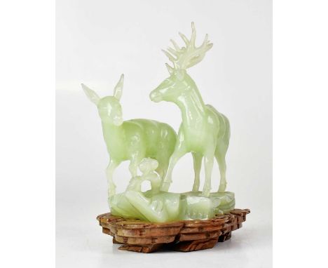 A green jade figure group of a stag and doe, on a fitted wooden base, 20 x 16 x 11cmCondition Report: Some chips to the antle