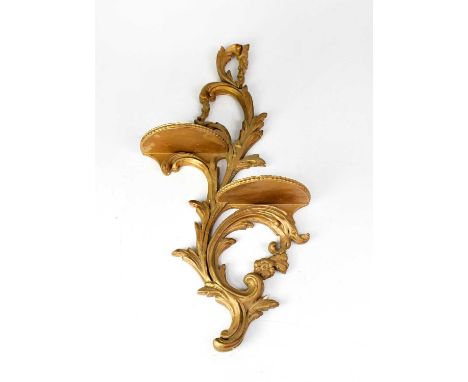 A Rococo-style gilded wall shelf with foliate scrolls and two small demi-lune shelves.
