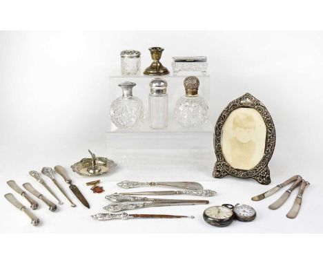 A collection of hallmarked silver items to include four silver-topped dressing table pots, a set of six silver-handled butter