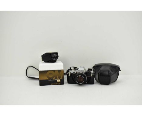 OLYMPUS; a cased model OM10 SLR 35mm camera, together with an OM system flash.Condition Report: Cannot guarantee working orde