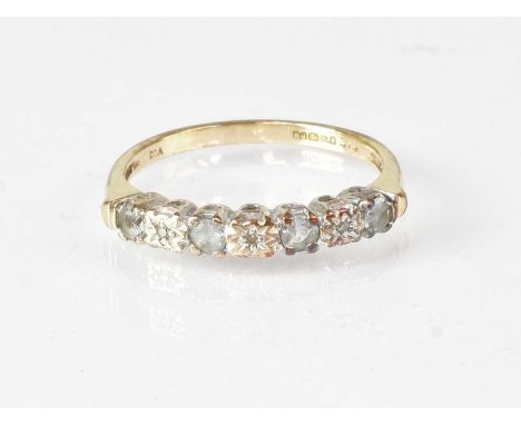 A 9ct gold ring set with white stones, marked 375, size M, approx. 1.9g.