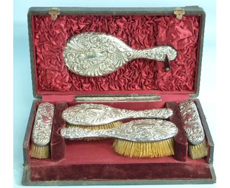 A cased Victorian silver backed six piece Dressing Table set, by William Neale, hallmarked Chester, 1896, comprising hand mir