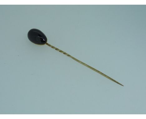 A gentleman's Stickpin, mounted in yellow metal, the finial with a teardrop almadine garnet.