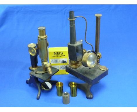 A vintage Microscope, black and brass, signed with crowned "DA&S" monogram, together with slides and accessories, including a