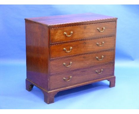 A Georgian mahogany Secretaire Chest, the secretaire drawer opening to reveal an interior fitted with compartments, drawers a