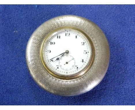 A George V silver Easel Clock, by William Neale, hallmarked Birmingham, 1921, of circular form with white enamel dial, Arabic