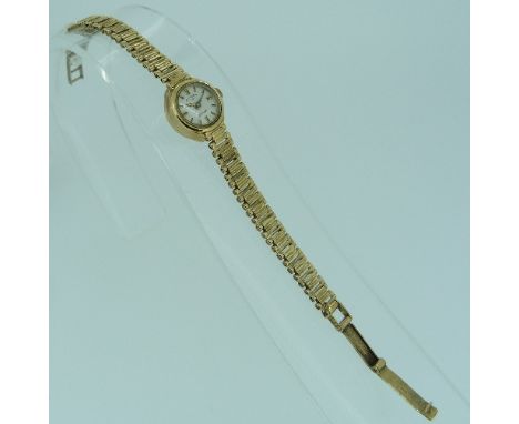 A 9ct yellow gold ladies Rotary Wristwatch, with white enamel and gold dial, on a flexible 9ct yellow gold bracelet, approx t