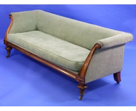 A Regency rosewood show-frame Sofa, with scrolling arms, low back and ogee-shaped front rail raised on turned turned legs and