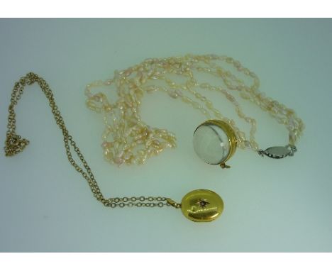 A small oval gold hinged Locket, marked 15ct, on gilt metal chain, together with crystal sphere, made into a hinged locket, a