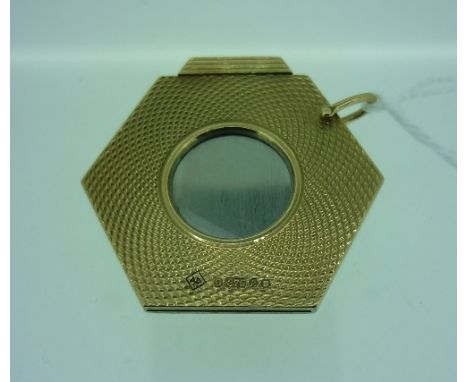 An Alfred Dunhill hexagonal engine turned 9ct yellow gold Cigar Cutter, London 1965, of Art Deco style, the open circular cen