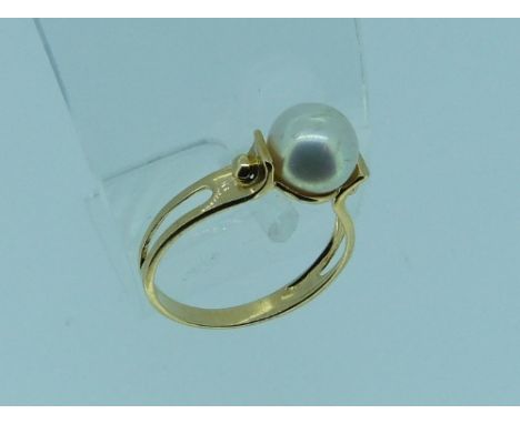 A Ring set with a cultured pearl, and mounted in a yellow gold shank, marked 750, Size O, together with a wide yellow metal r