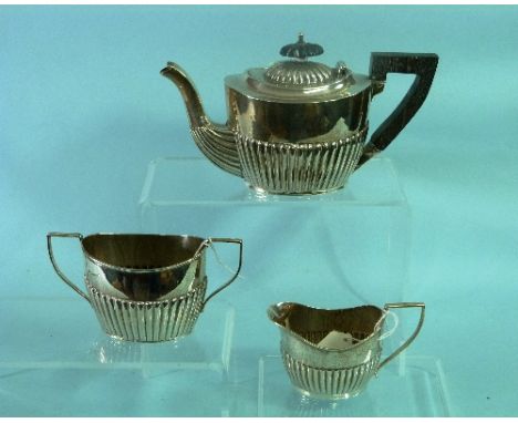 An Edwardian silver three piece silver Tea Set, by Eustace G. parker, hallmarked Birmingham, 1904, of ovoid form with demi fl