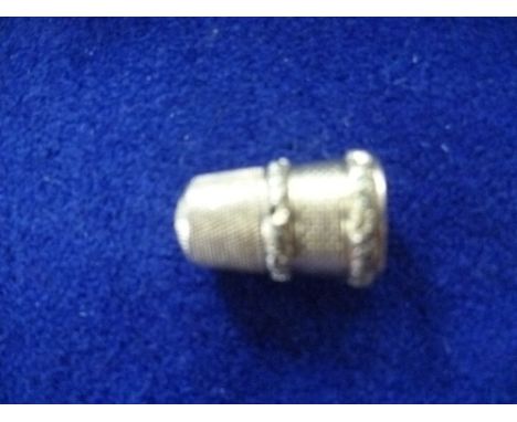 A Victorian yellow gold Thimble, with engine turned decoration and two bands of foliate engraved green gold decoration, later