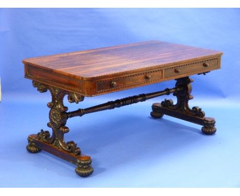 A Regency rosewood Sofa Table, with two opening frieze drawers on both sides, on scrolling carved supports, united by a turne