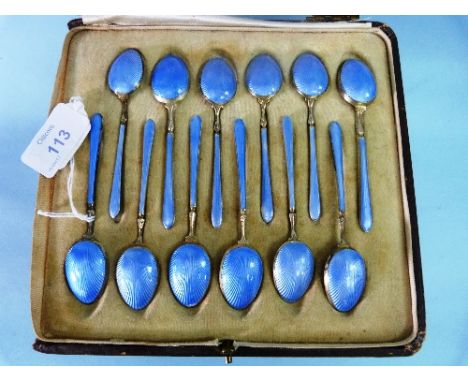 A cased set of twelve George V silver gilt and guilloche enamel Coffee Spoons, by Henry Matthews, hallmarked Birmingham 1926,