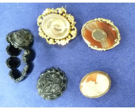 A carved jet Brooch, the oval boss with a flower, with rope loop border; a jet bracelet formed of polished oval links, the ce