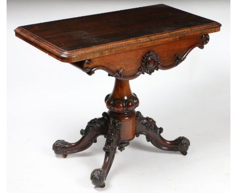 A Victorian rosewood card table, the rectangular top opening to reveal a circular green baize interior, with a scroll carved 