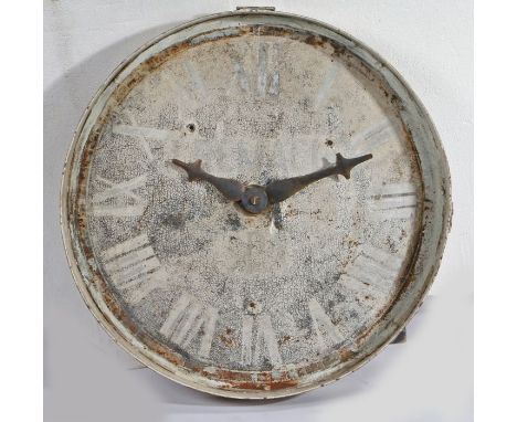 An early 20th century French metal clock face, the dial with Roman numerals and feint French inscription, 70cm diameter