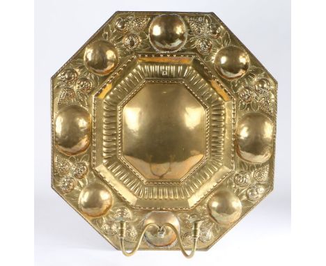 A large and impressive 19th century brass wall sconce

of elongated octagonal form, with a large central plain light reflecto