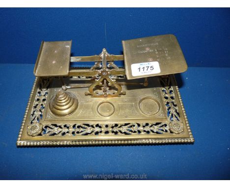 An old brass Post Office scales with weights.
