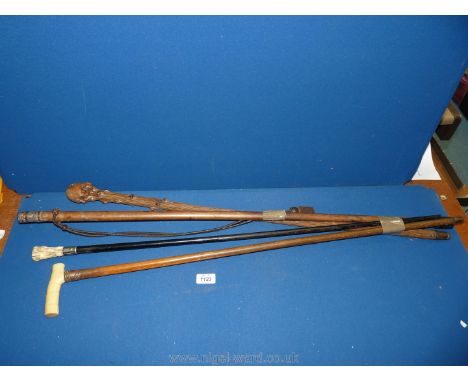 Four walking canes including one with leather thongs threaded through stick, copper collared, Blackthorn etc.