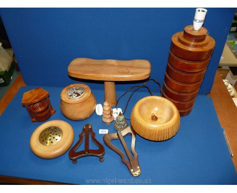 A quantity of treen including a lamp stand, pot pourri pots, wooden picture holders etc.