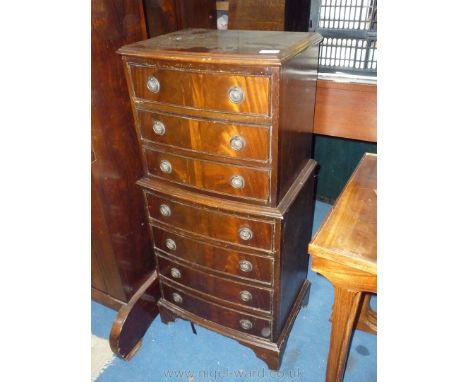 A tall compact Mahogany bow fronted Chest of three short over four short drawers, standing on bracket feet, 16 1/8'' wide x 1