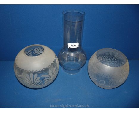 A large glass chimney for an oil lamp, 12'' tall and 6'' diameter at widest point, plus two globe etched glass Shades