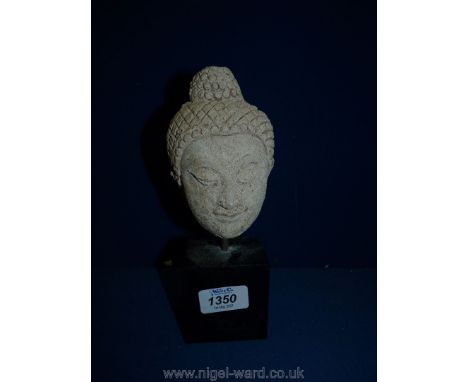 A vintage composition Head of The Buddha on a stand, 9" tall.