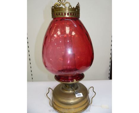 A Victorian church Oil/heater Lamp with squat brass fount standing on three squat feet, complete with handles and having a tu