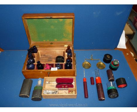 An interesting Apothecary Box, 12 1/2'' x 9'' x 5 1/2'', containing medicine bottles, blue and brown, measuring glasses in sh