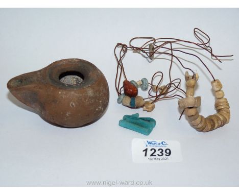 An Egyptian blue faience wajdet eye amulet, traces of old collection mounting to the rear, a string of ancient Egyptian beads