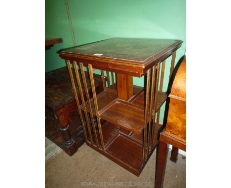 A Mahogany revolving Bookcase/Table having light and darkwood stringing and cross banding to the top and central shaded segme